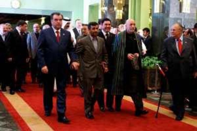 Iranian President Mahmoud Ahmadinejad (front-2nd L) arrives with his counterparts from Tajikistan, Emomali Rakhmon (L); Afghanistan,  Hamid Karzai (2nd R); and Iraq, Jalal Talabani, to open the summit of the regional Economic Cooperation Organisation (ECO) in Tehran on March 11, 2009. In an opening speech, Iran's hardline president accused the United States and other world powers of creating an "unfair" economic order which has triggered the global financial crisis. The summit of ECO -- a regional organisation founded in 1985 by Iran, Pakistan and Turkey -- aims to focus on the global financial crisis and its impact on the region. AFP PHOTO/ATTA KENARE *** Local Caption ***  Nic346803.jpg