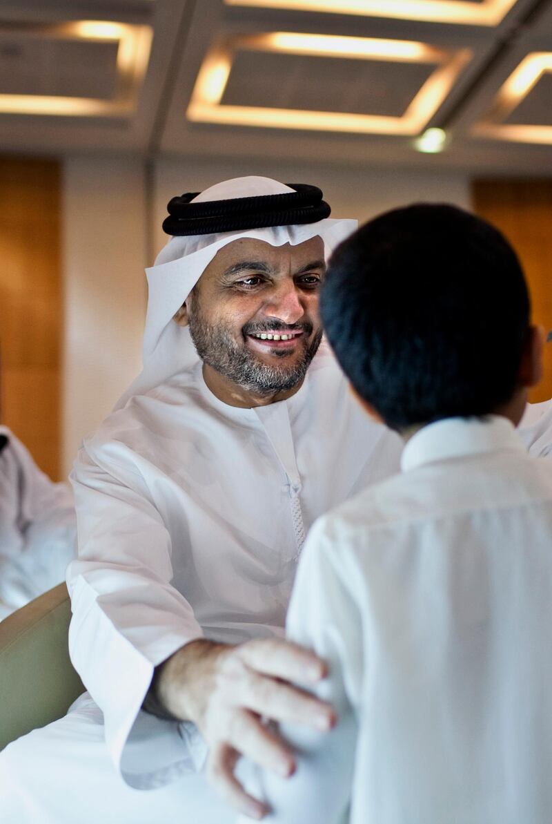 A Federal National Council candidate Ing. Salem bin Hashil al Ameri talks with his son Mohammed, 2,  as he registers for the FNC election on Wednesday, August 17, 2011, the last day of registration at the Abu Dhabi National Exhibition Center in Abu Dhabi. The previous three days brought in 71 people. (Silvia Razgova/The National)


