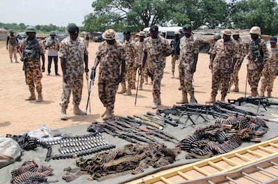 Military commanders inspect arms and ammunitions recovered from Boko Haram militants in Nigeria. (Photo by AUDU MARTE / AFP)