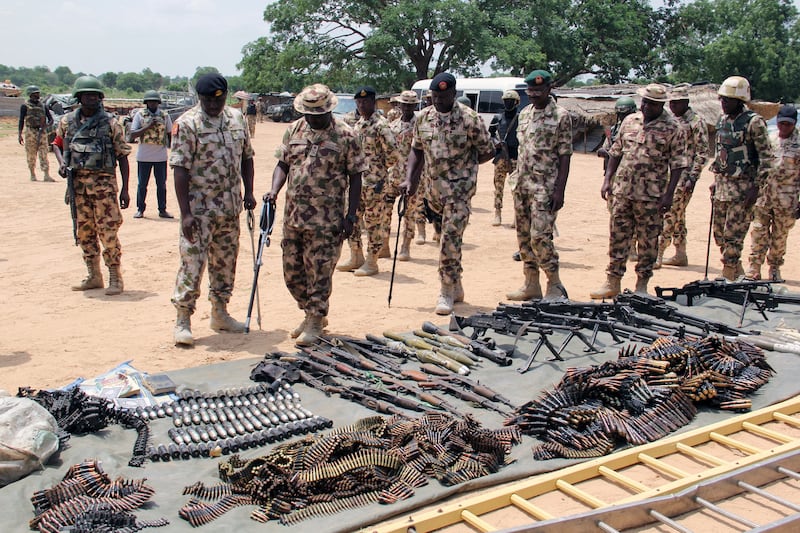 Military commanders inspect arms and ammunitions recovered from Boko Haram militants in Nigeria.