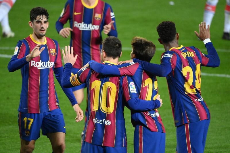 Barcelona's Lionel Messi celebrates with teammates afer scoring their second goal. AFP