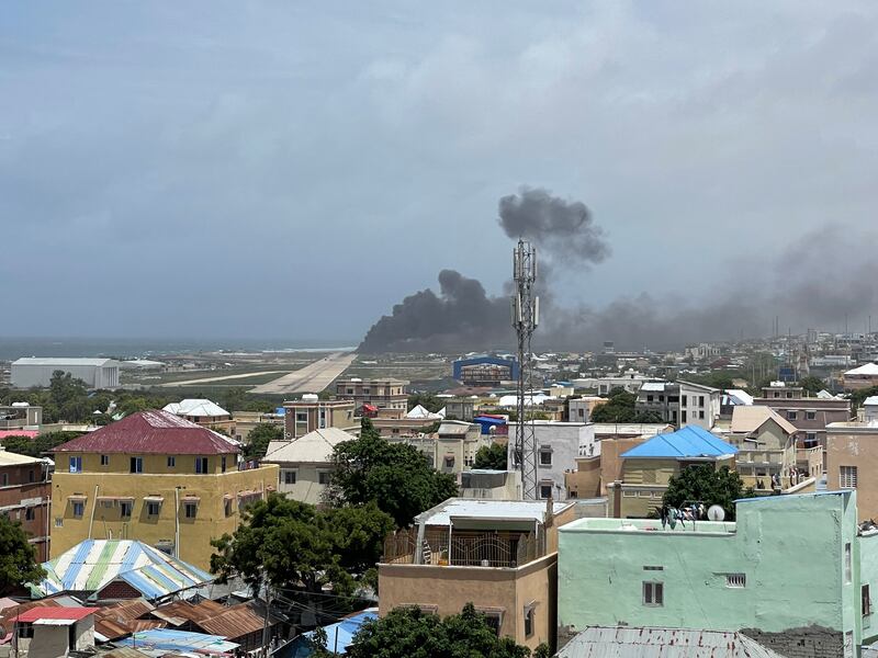 Smoke billows from a plane that flipped over after a crash landing, in Mogadishu, Somalia in this picture obtained from social media. Photo: Abdirahman Mohamed Arab via Reuters