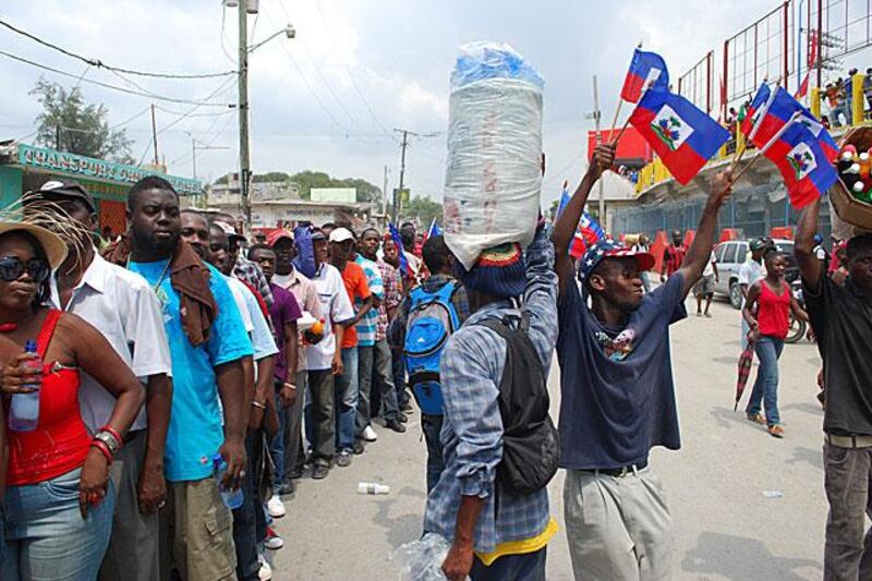 Fans queue outside the stadium in anticipation for their first home match since the Haitian earthquake last year.