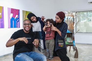 Bait 15 artists Hashel Al Lamki, Afra Al Dhaheri and Maitha Abdalla, who poses with her son, Mubarak. Victor Besa / The National 