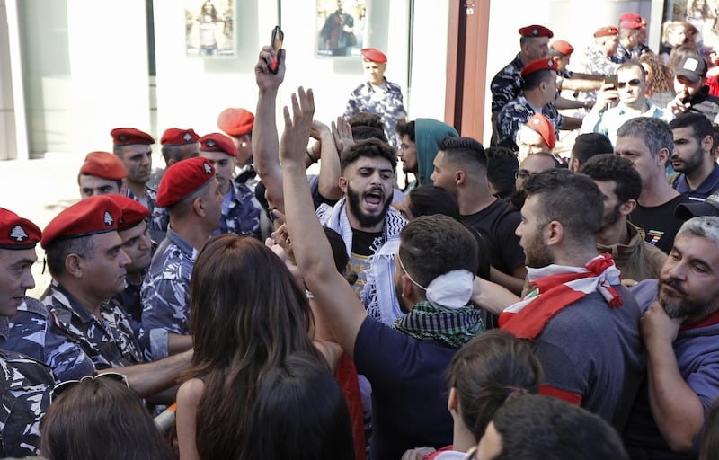 Lebanese protestors trying to reach the parliament in Beirut scuffle with security forces.
 AFP