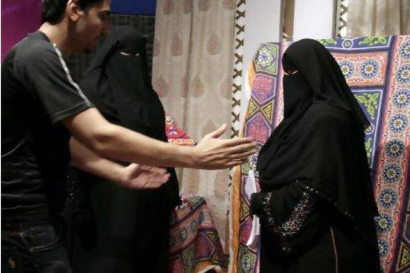 Mohy Abozeid, left, directs presenter Nahla Hashad, right, and Shaimaa Abdelhameed, second left, as they prepare to film a segment of a Ramadan program at the Maria Channel's studio in Cairo, Egypt, Monday, July 23, 2012. The first Egyptian satellite channel operated by women wearing the niqab, or face veil, launched on the first day of the holy month of Ramadan. The station manager says he hopes†the full face-veiled women†will set an†example for others†by showing a "new kind of woman" as a role model.(AP Photo/Maya Alleruzzo) *** Local Caption *** Mideast Egypt Maria Channel.JPEG-06b86.jpg