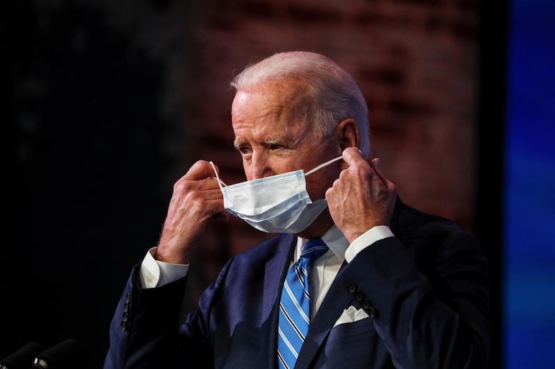 US President-elect Joe Biden removes his face mask to deliver remarks for a televised speech on the current economic and health crises at The Queen Theatre in Wilmington, Delaware, USA. Reuters