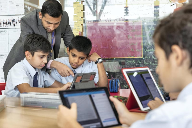 DUBAI, UNITED ARAB EMIRATES. 24 MAY 2018. Students at the Kings School in Al Barsha uses the Pobble app on ipads during a class at school. Mr Imran Akhtar helps Rishabh Diniz (11) and Mohsin Muhammad (11) with their lesson. (Photo: Antonie Robertson/The National) Journalist: Anam Rizvi. Section: National.