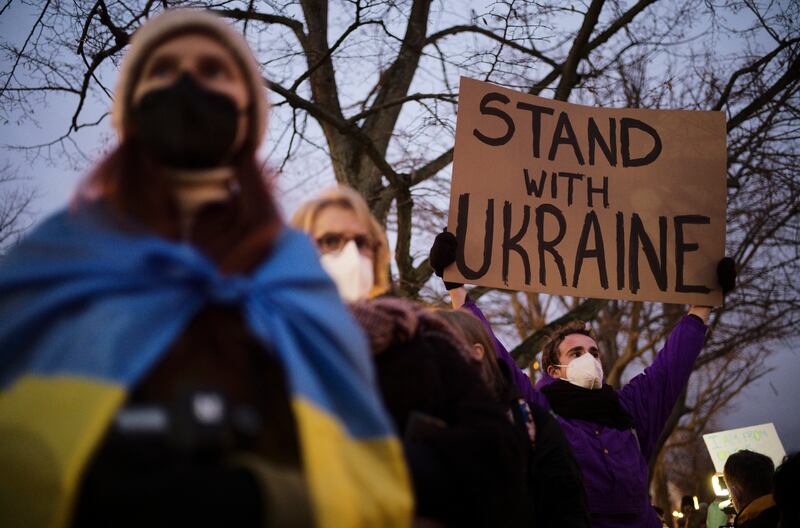 A man shows a poster in support of Ukraine as he protests against the escalation of the tension between Russia and Ukraine, in Berlin. AP