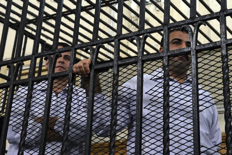  Awad Suliman, right, and Mahmoud Salah, stand behind bars during the sentencing hearing of their retrial in the landmark case of the beating to death of 28-year-old Khaled Said. AP Photo/ 3 March, 2014