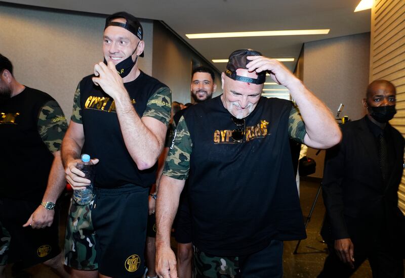 WBC heavyweight champion Tyson Fury, left, did not see the fracas that left in his dad, John Fury, with blood on his face after a fracas with Oleksandr Usyk's camp. PA
