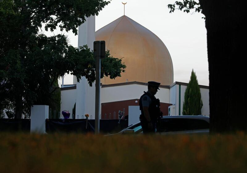 FILE - In this March 17, 2019, file photo, a police officer stands guard in front of the Al Noor mosque in Christchurch, New Zealand. New Zealand's major media organizations pledged Wednesday, May 1, 2019, not to promote white supremacist ideology when covering the trial of the man charged with killing 50 people at two mosques.(AP Photo/Vincent Yu, File)