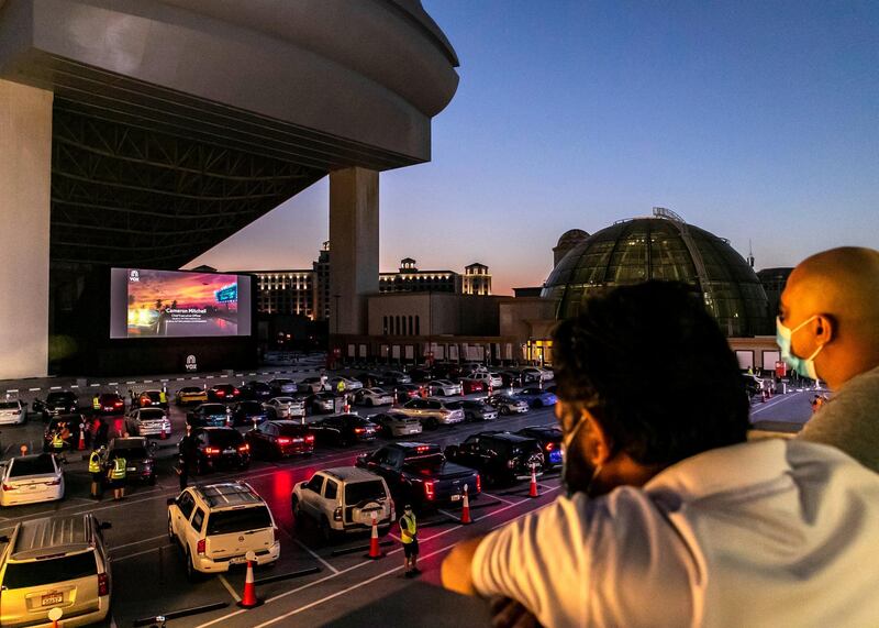 DUBAI, UNITED ARAB EMIRATES. 13 MAY 2020. 
The drive-in cinema is making a comeback at Mall Of The Emirates, as the property and VOX Cinemas take the movie-going experience outdoors.

With social distancing measures keeping traditional theatres closed for the foreseeable future, a large screen has been assembled in the shopping centre's upper parking lot (level 3 near Ski Dubai) in front of which patrons will be able to take position, switch off their engines and settle in for some silver screen action all while observing sensible practices to combat the COVID-19 pandemic.  

(Photo: Reem Mohammed/The National)

Reporter:
Section: