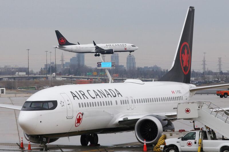 FILE PHOTO: An Air Canada Boeing 737 MAX 8 from San Francisco approaches for landing at Toronto Pearson International Airport over a parked Air Canada Boeing 737 MAX 8 aircraft in Toronto, Ontario, Canada, March 13, 2019.  REUTERS/Chris Helgren/File Photo