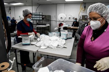 Employees work as they make respiratory masks in a factory in Florida. Women, minorities, the young and the less educated will probably be the hardest hit by the pandemic. AFP