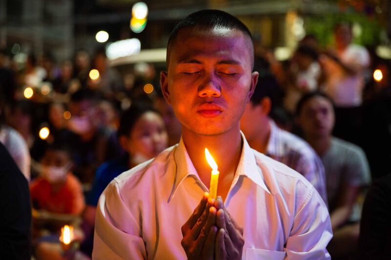 KORAT, THAILAND - FEBRUARY 09:  Thai mourners attend a candlelight vigil for the victims of the Terminal 21 Mall shooting on February 9, 2020 in KORAT, Thailand. On Saturday February 8 at Terminal 21 Mall in Korat, a city in Nakhon Rachasima, three hours from Bangkok, Sgt. Maj. Jakrapanth Thomma opened fire and killed 26 people and wounded 57 others in a 16 hour rampage before being shot down by Thai Police. (Photo by Lauren DeCicca/Getty Images)