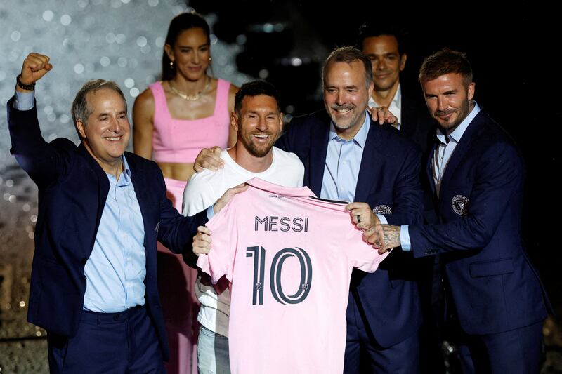 New Inter Miami signing Lionel Messi poses with a club shirt alongside owners Jorge Mas, left, Jose Mas and David Beckham, right, during the unveiling at DRV PNK Stadium in Fort Lauderdale, Florida, on Sunday, July 16, 2023. Reuters