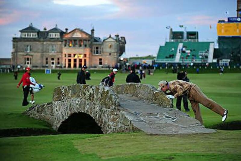 Tom Watson kisses the Swilken Bridge as he said an emotional farewell to the galleries at St Andrews on Friday.