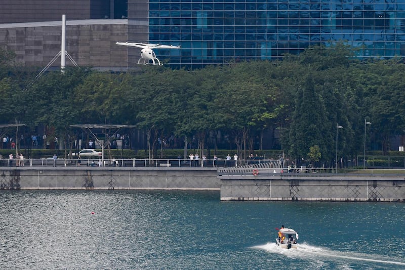 A Volocopter unmanned air taxi transport flies over Marina Bay during test flight with a safety pilot at the 26th Intelligent Transport Systems World Congress (ITSWC) in Singapore.  AFP