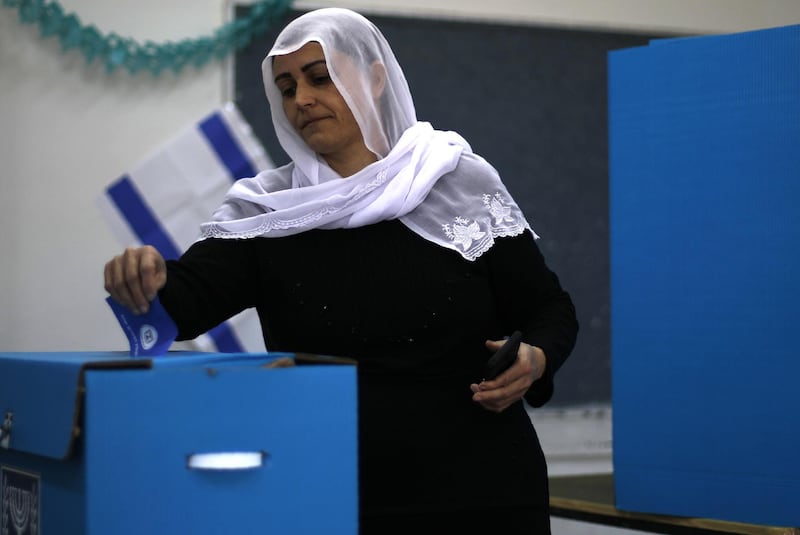 An Israeli Druze woman casts her vote during Israel's parliamentary elections. AFP