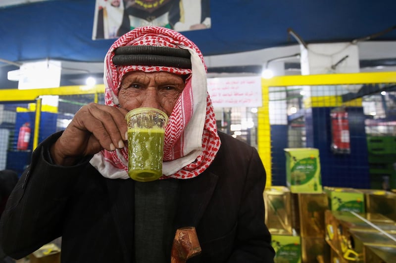 A Jordanian man tastes freshly-pressed olive oil at an automatic press in Mahis, west of the capital Amman. AFP