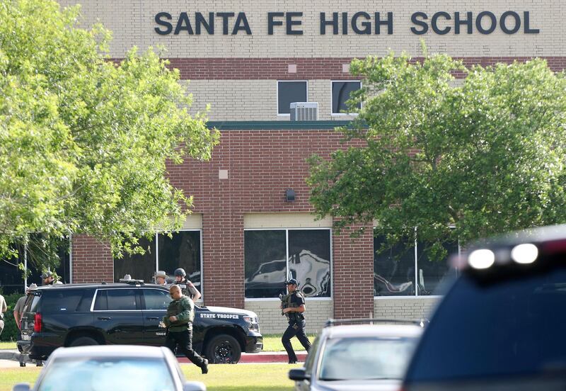 Law enforcement officers respond to Santa Fe High School after an active shooter was reported on campus, in Santa Fe, Texas. Steve Gonzales / AP Photo