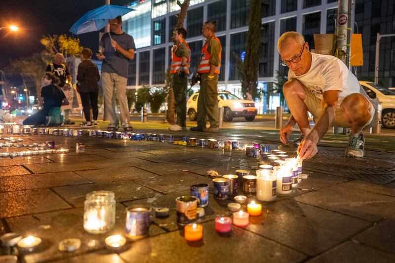 Families and supporters of people kidnapped by Hamas light candles in Tel Aviv in memory of more than 1,300 people killed when the militants attacked Israeli settlements on October 7. Getty Images