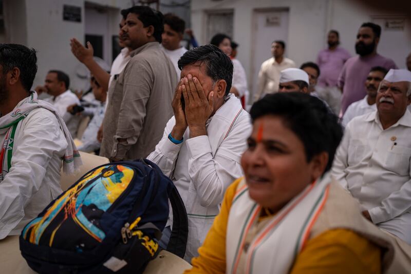 Congress supporters watch the live broadcast of vote counting at the party's headquarters in New Delhi. AP