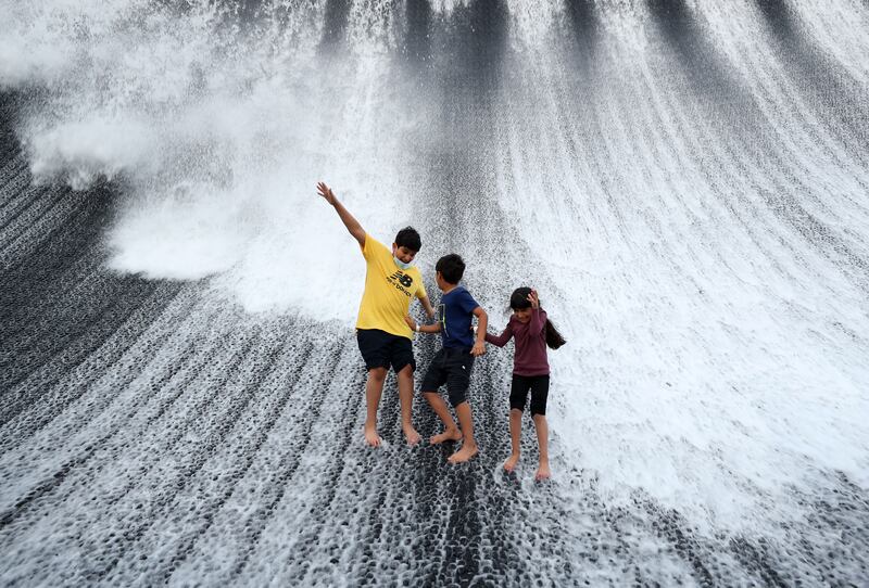 Visitors enjoy a water feature at the world’s fair. Chris Whiteoak / The National