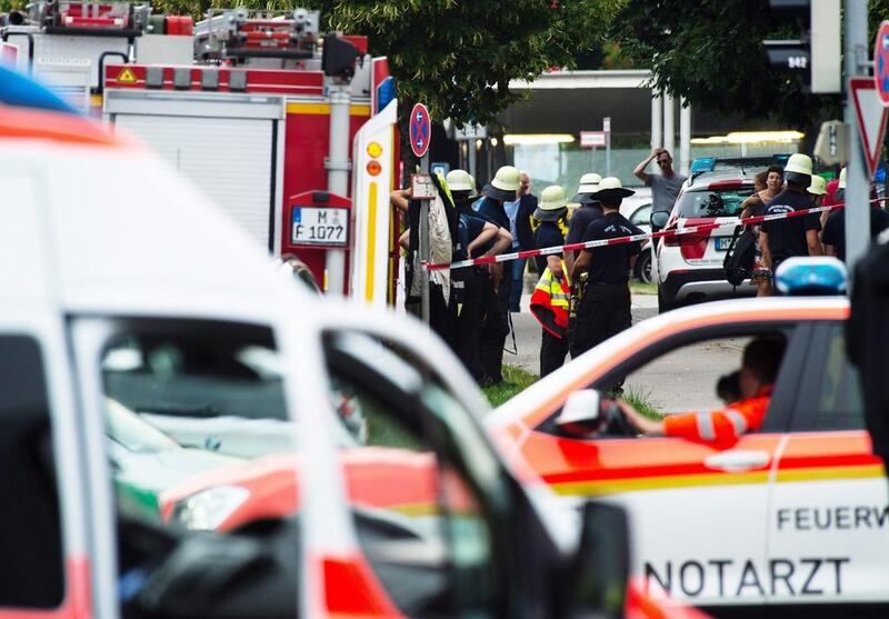 Fire fighters gather at the entrance of the OEZ shopping centre on July 22, 2016. Matthias Balk / EPA