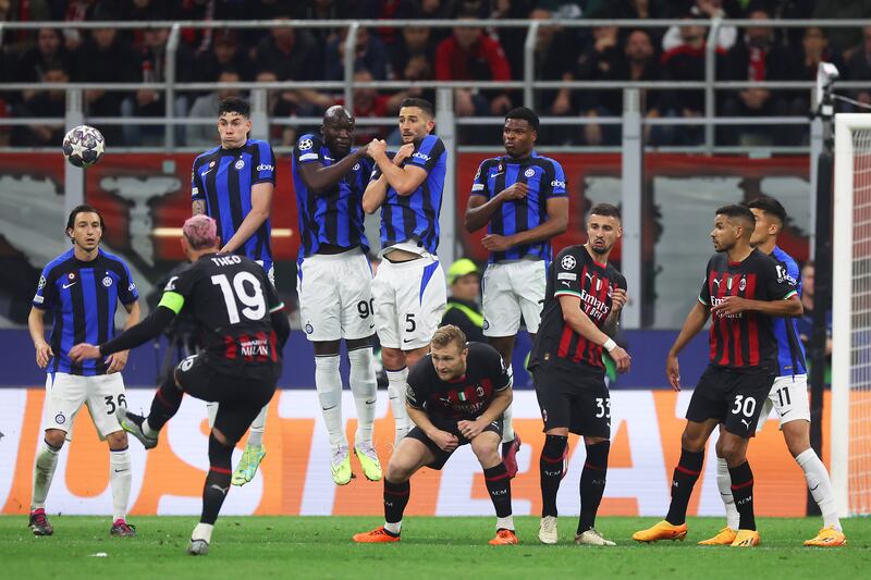 Theo Hernandez of AC Milan takes a free kick as Alessandro Bastoni, Romelu Lukaku, Roberto Gagliardini and Denzel Dumfries of Inter jump in the wall. Getty 