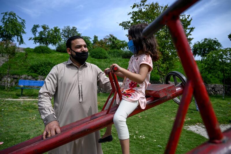 Aamir Gill plays with his daughter in a public park near a Christian neighbourhood in Islamabad, Pakistan. AFP