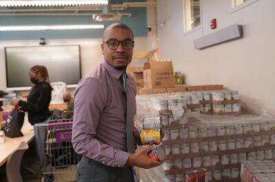 Kenrick Thomas, communications and events manager at Bread for the City, sifts through canned goods. Willy Lowry / The National