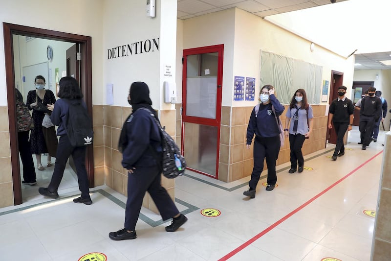 SHARJAH, UNITED ARAB EMIRATES , September 28 – 2020 :- Students of grade 11 going to their class on the first day of the school after reopening at the Victoria English School in Sharjah. New Covid safety setup placed in different areas of the school such as hand sanitizer, safety message, social distancing stickers pasted on the floor, disinfection tunnels installed at all the gates of the school. (Pawan Singh / The National) For News. Story by Salam