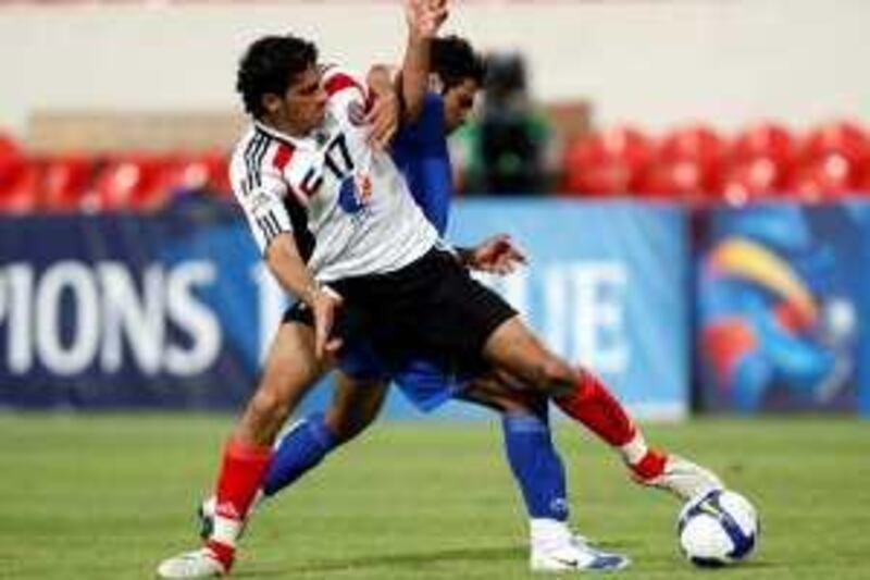 May 19, 2009 / Abu Dhabi /  Saleh Obaid, (17) with Al Jazira, and Omid Ravankhah (23) with Iran, fight for possession of the ball during a football match played at Al Jazira May 19, 2009. During an Asian Football Champins League game.  (Sammy Dallal / The National)
 *** Local Caption ***  sd-051909-football-08.jpg sd-051909-football-08_Cropped.jpg