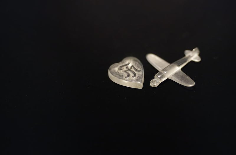 A heart and a Zero fighter shaped pendants carved out of cockpit glass made by kamikaze Masao Kanai for the girl he was courting Toshi Negishi.