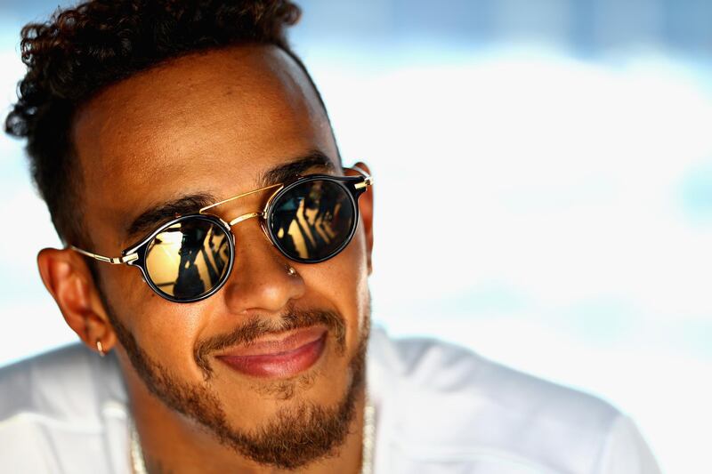 MELBOURNE, AUSTRALIA - MARCH 22:  Lewis Hamilton of Great Britain and Mercedes GP smiles in the Paddock during previews ahead of the Australian Formula One Grand Prix at Albert Park on March 22, 2018 in Melbourne, Australia.  (Photo by Mark Thompson/Getty Images)