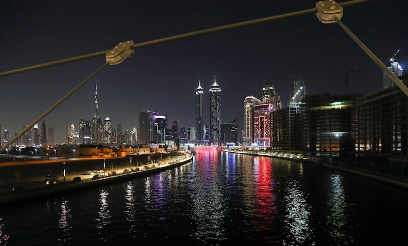 Dubai Canal'a waterfall is illuminated. EPA