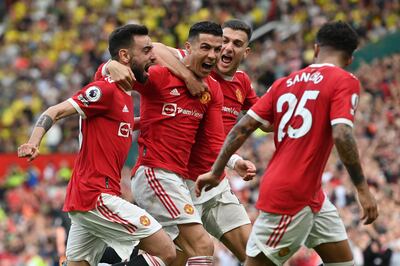 Cristiano Ronaldo celebrates with Manchester United teammates after scoring his third goal against Norwich City on April 16, 2022. AFP