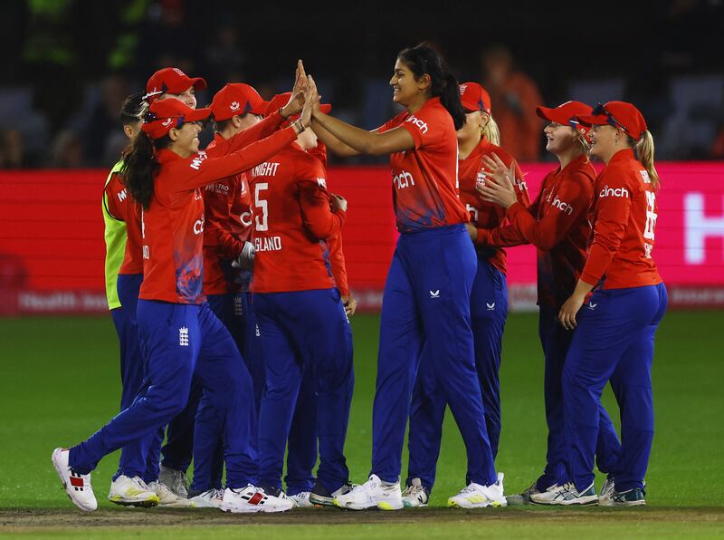England teammates celebrate with Mahika Gaur. Reuters