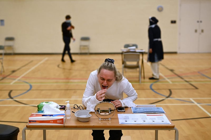 A teacher takes a Covid-19 lateral flow test in the sports hall of Park Lane Academy in Halifax, northwest England, as the school prepares to reopen. AFP