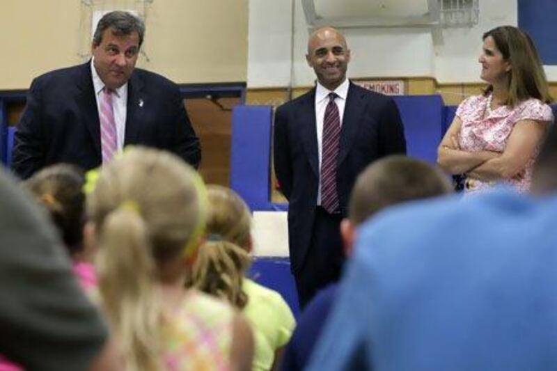 New Jersey Gov. Chris Christie, left, his wife Mary Pat Christie, and Yousef Al Otaiba, UAE Ambassador to the United States, visit a school in Highlands, New Jersey. AP Photo