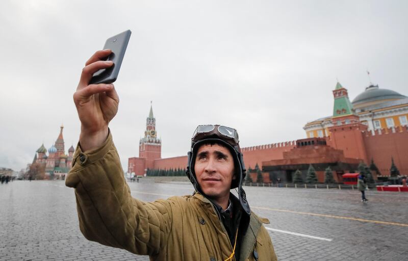 A Russian army member, dressed in a historical uniform, takes a selfie as he attends a rehearsal for a military parade to mark the anniversary of a historical parade in 1941, when Soviet soldiers marched towards the front lines at the Red Square in Moscow. Maxim Shemetov / Reuters