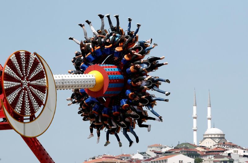 People enjoy a ride in an amusement park as they celebrate the second day of Eid al-Fitr in Istanbul, Turkey. Reuters