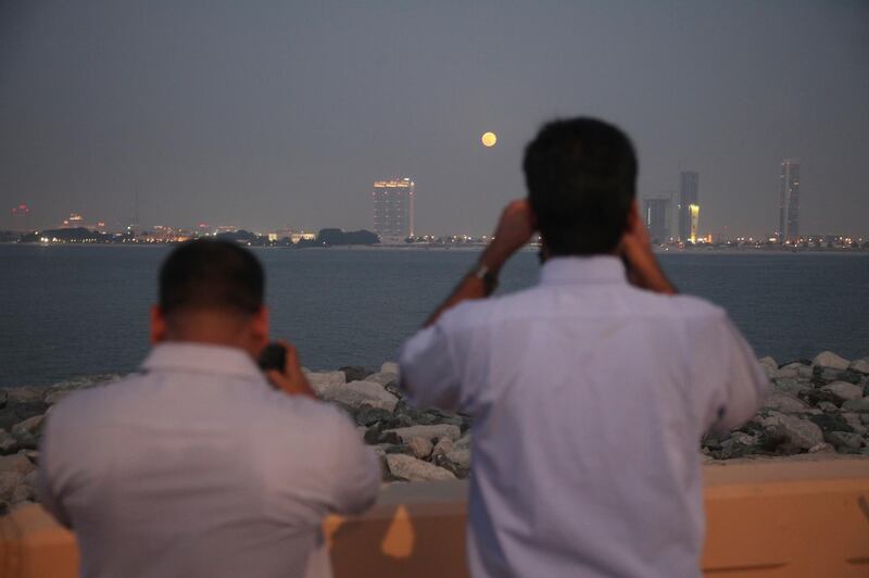 Dubai, UAE, June 23, 2013:

Photography enthusiasts descended upon the crescent of the Palm Jumeirah to photograph tonight's super moon. 
Seen here are the shutterbugs photographing the moon's first appearance in the night sky. 

Lee Hoagland/The National *** Local Caption ***  LH2306_MOON_FILE_013.JPG
