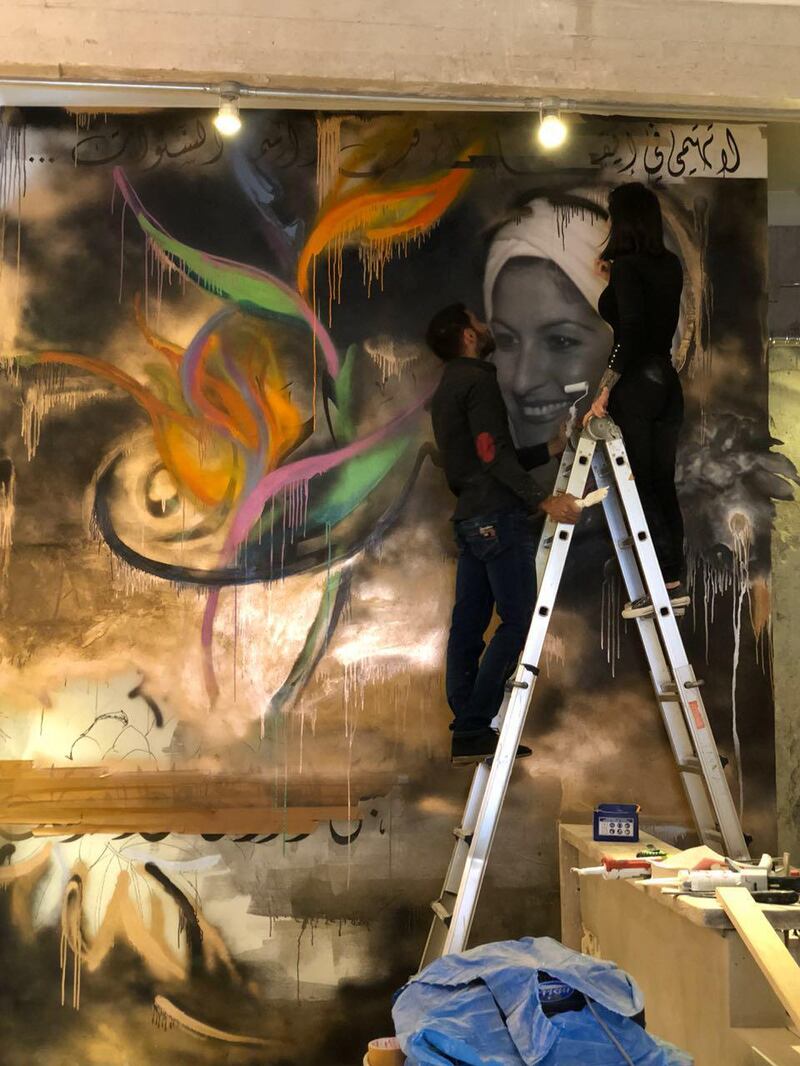 Farah Malhas painting a mural in her Beirut cafe. Farah Malhas
