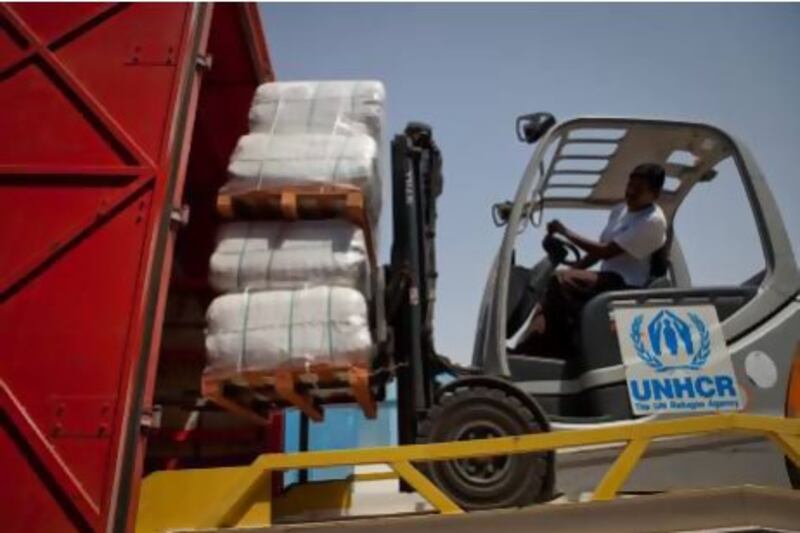 The 33 vehicles, carrying Dh4.4 million of relief aid, left the UNHCR warehouse in Dubai Humanitarian City on a route that will take them through Saudi Arabia and Jordan, eventually reaching Syria in around 14 days. Razan Alzayani / The National