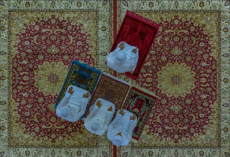 In Al Ain, three family members performing the Asr prayer at home, following the closure of mosques due to the pandemic. Taken by Emirati photographer Salem Sarhan, this work is the winner of the National Geographic Abu Dhabi and Almarai’s 2020 ‘Moments’ competition. Photo by Salem Sarhan.