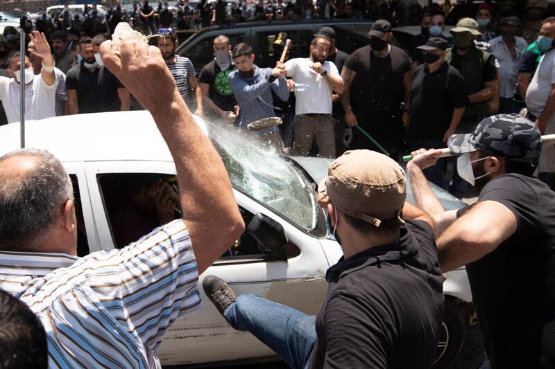 A mob attacks a car north of Beirut carrying voters heading to the Syrian embassy to vote. AP Photo