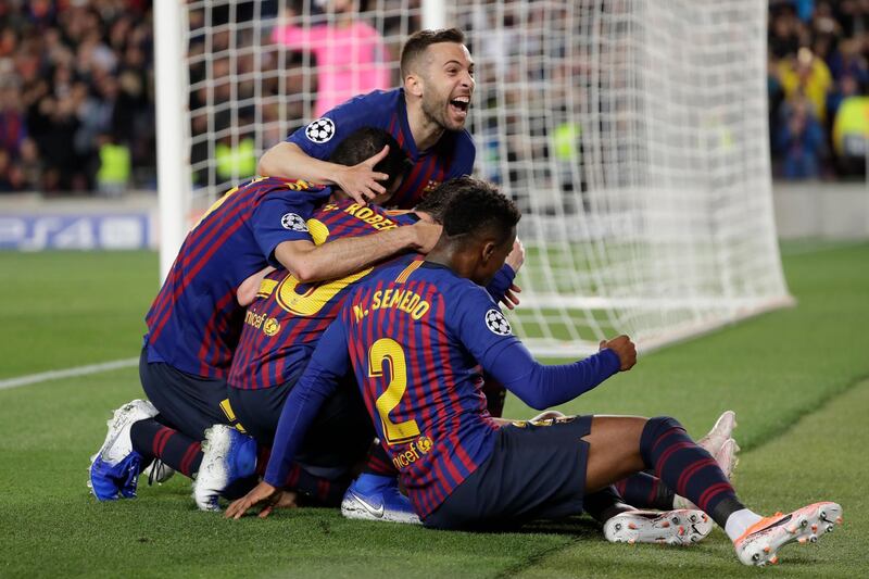 Barcelona players celebrate after Lionel Messi scored his side's third goal. Emilio Morenatti / AP Photo